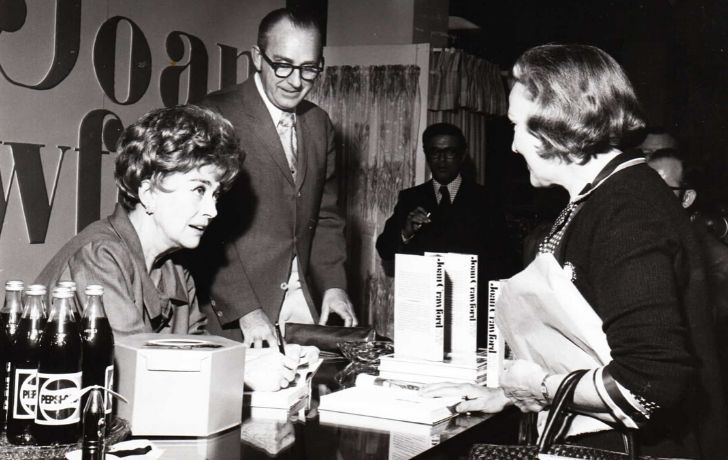 Joan Crawford with bottles of Pepsi on the table