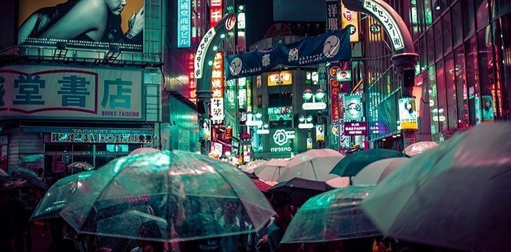 There are vases with umbrellas on the streets.