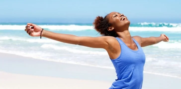 A happy and care free woman on a beach