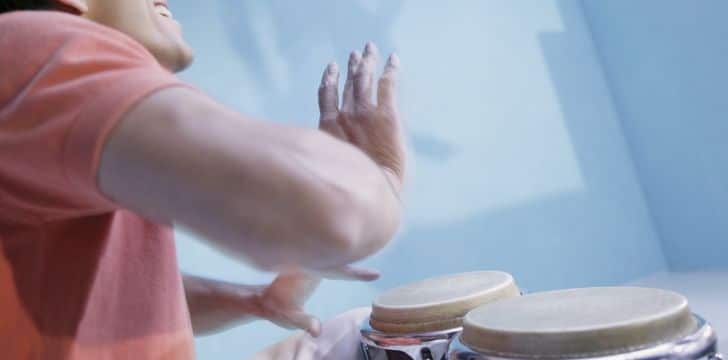 A Bongosero playing the bongo drums.