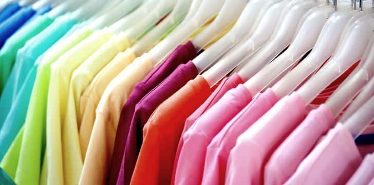 Different colored clothes on a rail