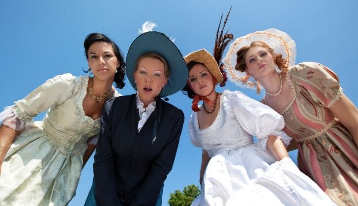 A group of friends wearing period costumes