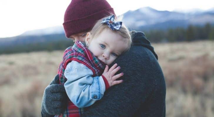 A father hugging his young daughter toddler