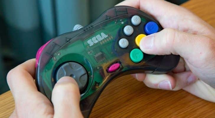 Someone holding a Sega Saturn controller