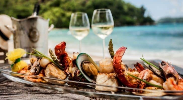 Fine dining on seafood with the ocean in the distance