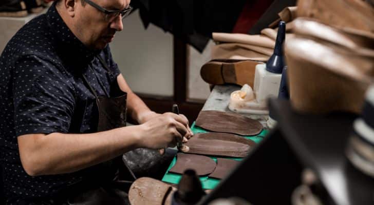 A shoe cobbler working in his workshop.