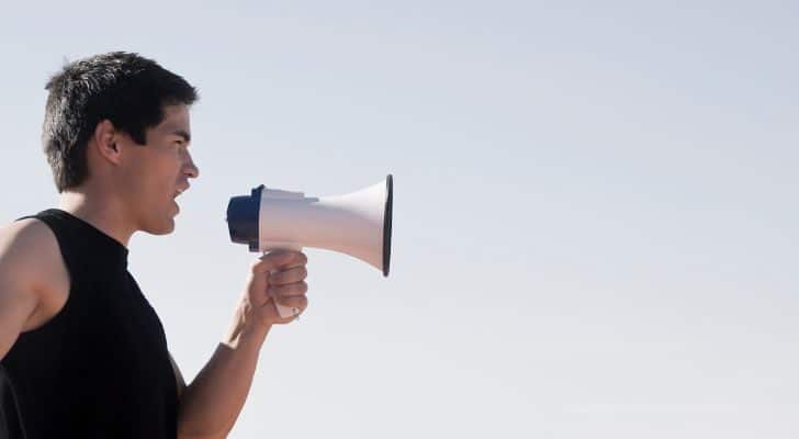 A man confessing using a megaphone