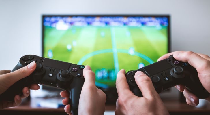 Two people playing a Soccer Video game on the Playstation 4