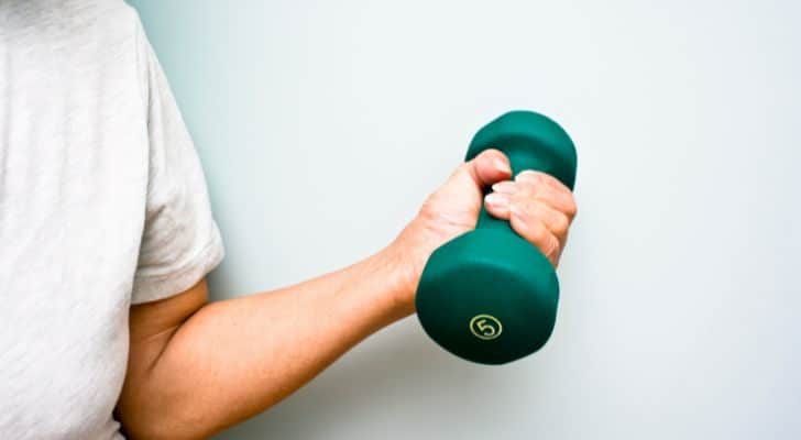 A woman's hand grasps a dumbbell