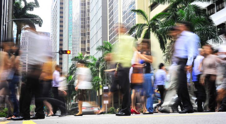 People on the streets of Singapore walking around quickly