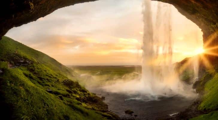 A view of a waterfall in Iceland during sunset