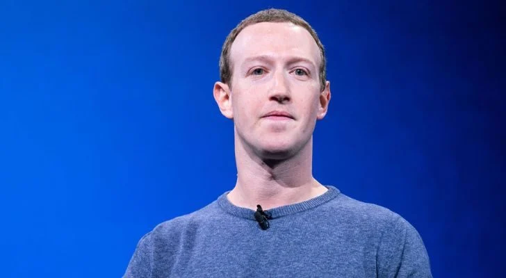 Mark Zuckerberg in front of a blue screen