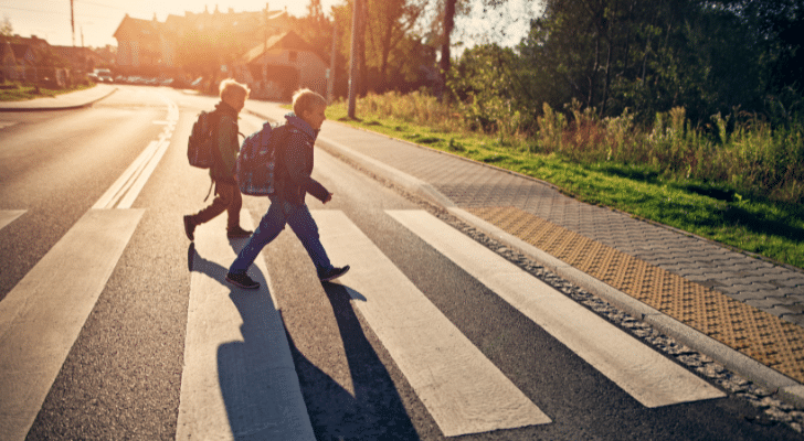 Two young children walking to school on their own