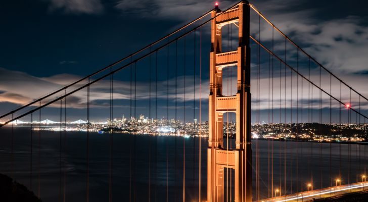 The San Francisco bridge at night with San Francisco in the distance