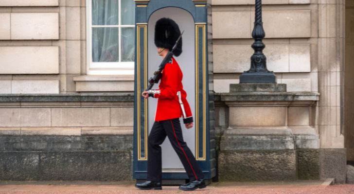 A guard patrolling Buckingham Palace in the classic bearskin uniform