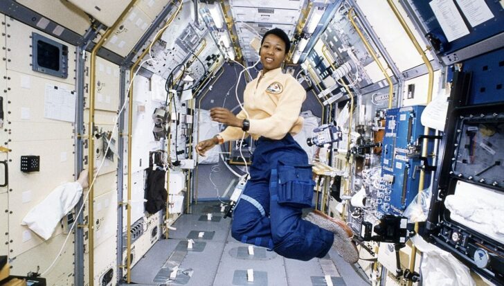 Mae Jemison in a spacecraft interior, surrounded by scientific equipment and control panels