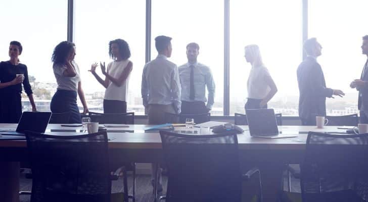 A group of people in a boardroom discussing a topic