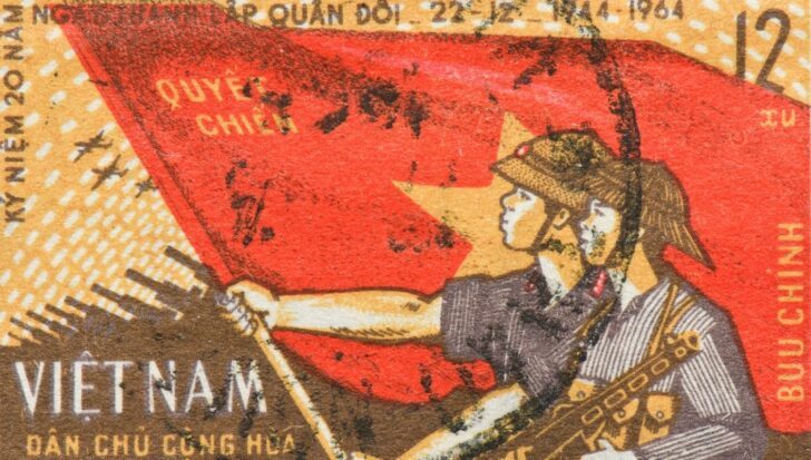 Vintage Vietnamese postage stamp featuring soldiers and a red star flag, reflecting Vietnam War themes