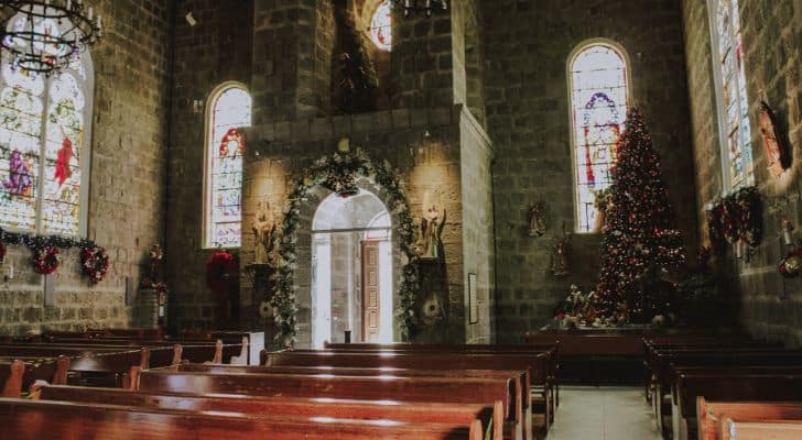 The interior of a stone church with Christmas decorations