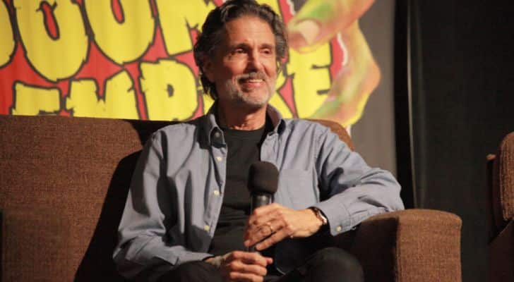 Chris Sarandon sitting on a couch during an interview