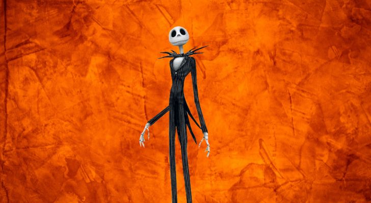 Jack Skellington standing against a bright orange background