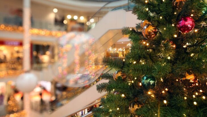 Christmas tree decorated with lights and ornaments in a shopping mall