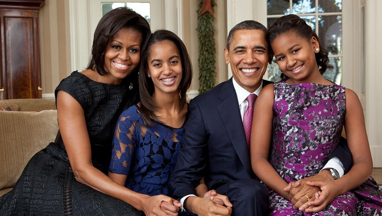 Barack Obama with his wife and two daughters in the Oval Office in 2011