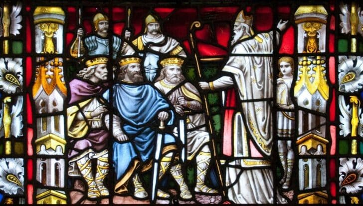 Stained glass depiction of Saint Patrick addressing several seated Irish kings, set against an ornate background