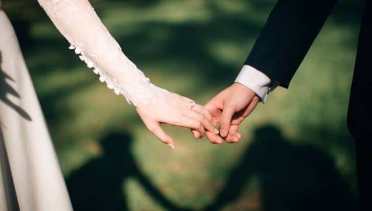 A couple holding hands at a wedding