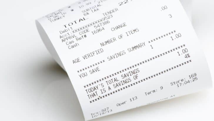Close-up of a paper shopping receipt with printed text and numbers