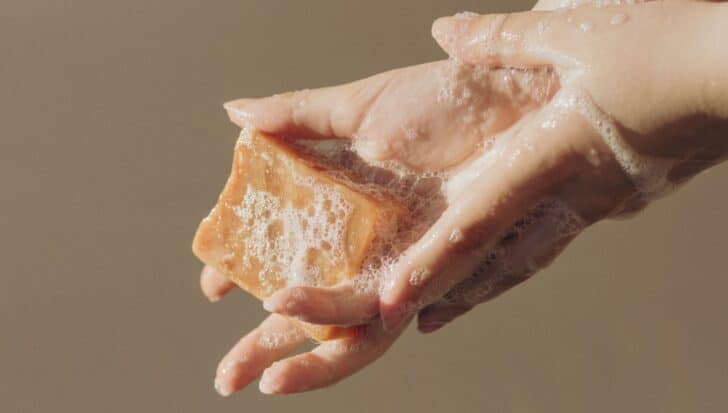Hands lathered with soap, illustrating the cleaning process