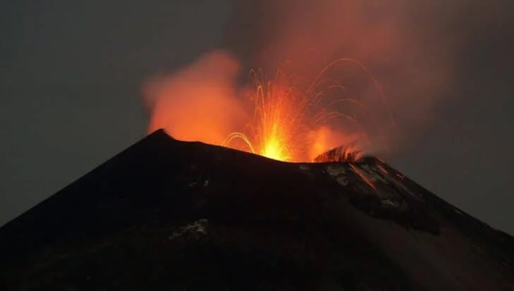 Krakatoa erupting with vibrant lava and ash clouds against a dark sky