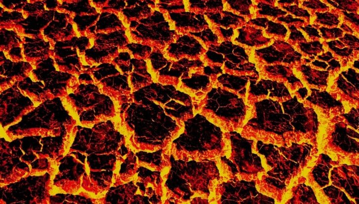 Close-up view of lava cooling and cracking, displaying bright red and orange colors indicating extremely high temperatures