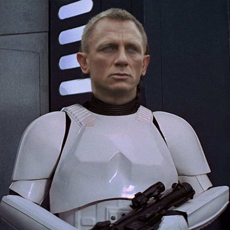 Daniel Craig dressed as a Stormtrooper, holding a blaster, from The Force Awakens