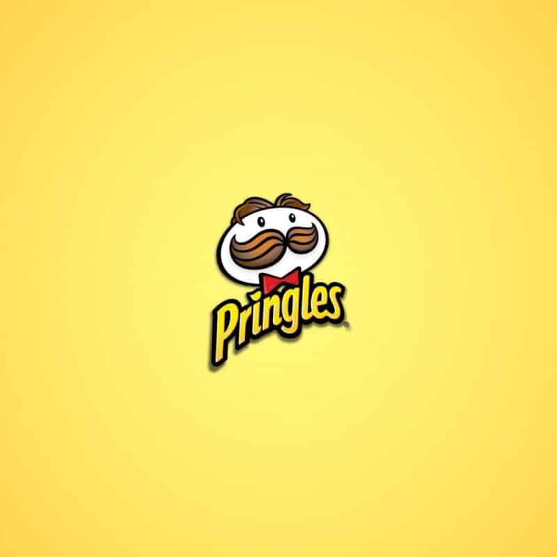 Close-up of the Pringles logo, featuring the mustached face with red bow tie on a yellow background