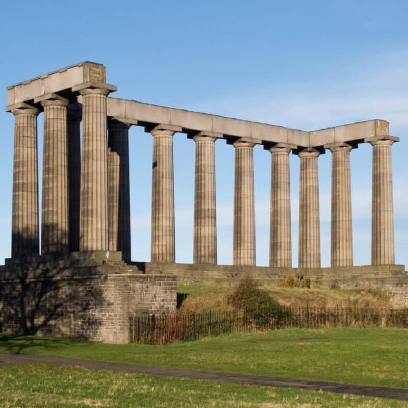 Partially built stone columns of a structure resembling the Parthenon in Athens