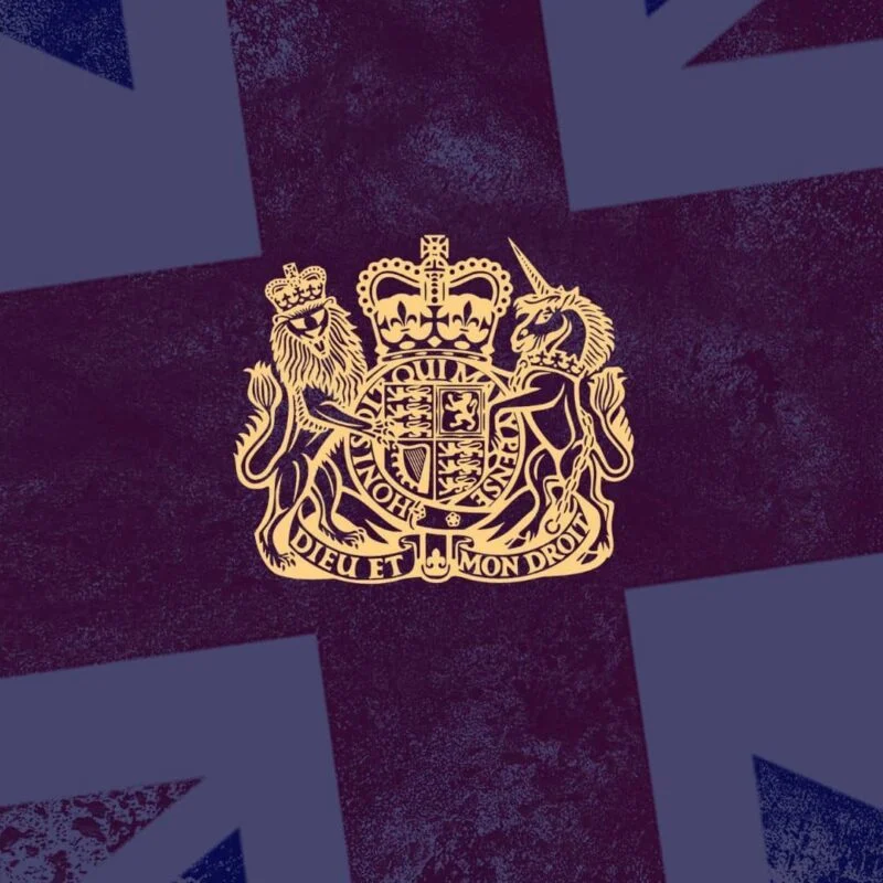 The Royal Coat of Arms of the United Kingdom against a stylized background resembling the Union Jack
