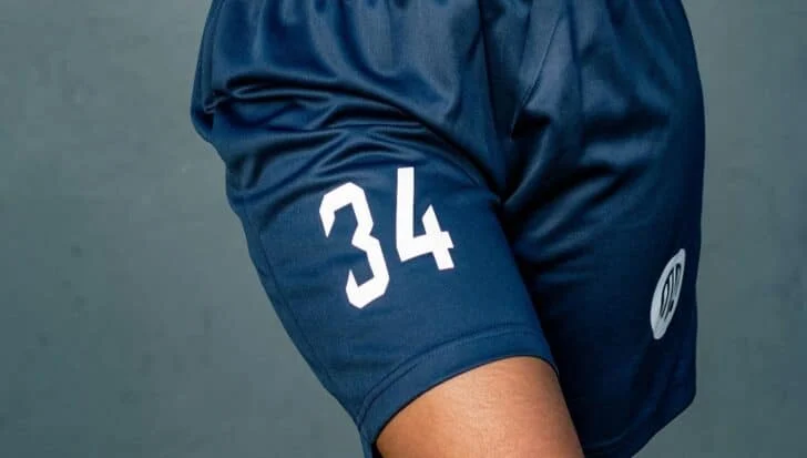 Blue sports shorts with the number 34 printed in white