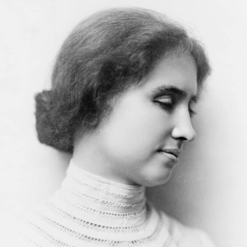 Helen Keller with her hair up, wearing a high-collared, lace blouse