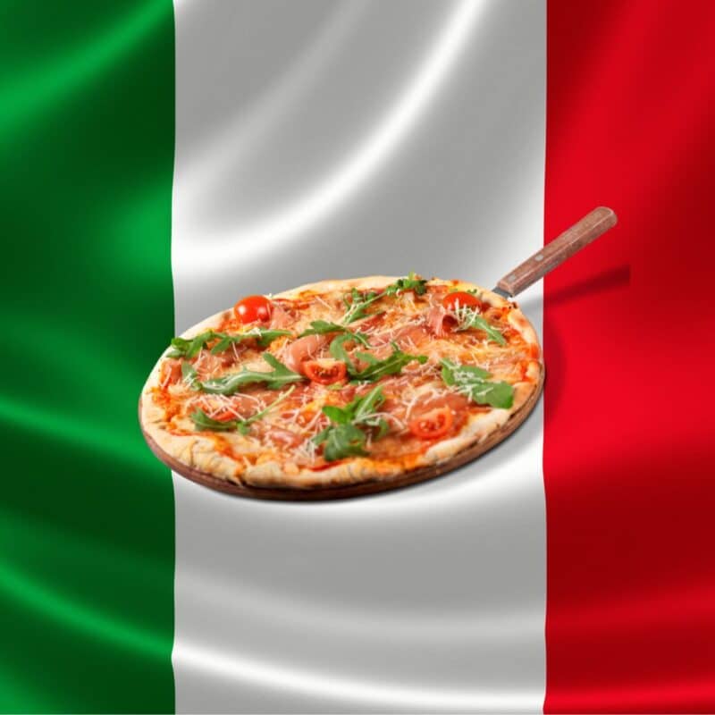 Margherita pizza with tomatoes, mozzarella, and basil in front of the Italian flag