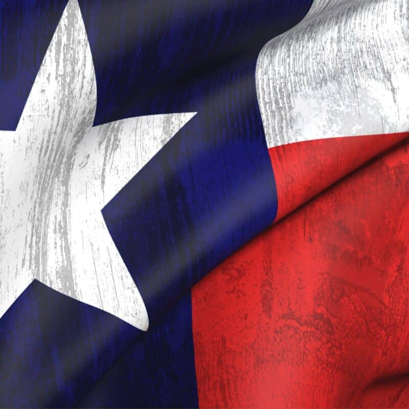 Worn texture of the Texas Lone Star flag with blue, white, and red sections