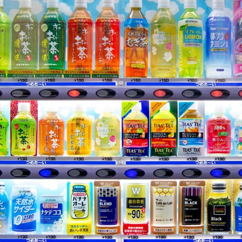 Vending machine displaying various bottled beverages, including teas, flavored water, and coffee
