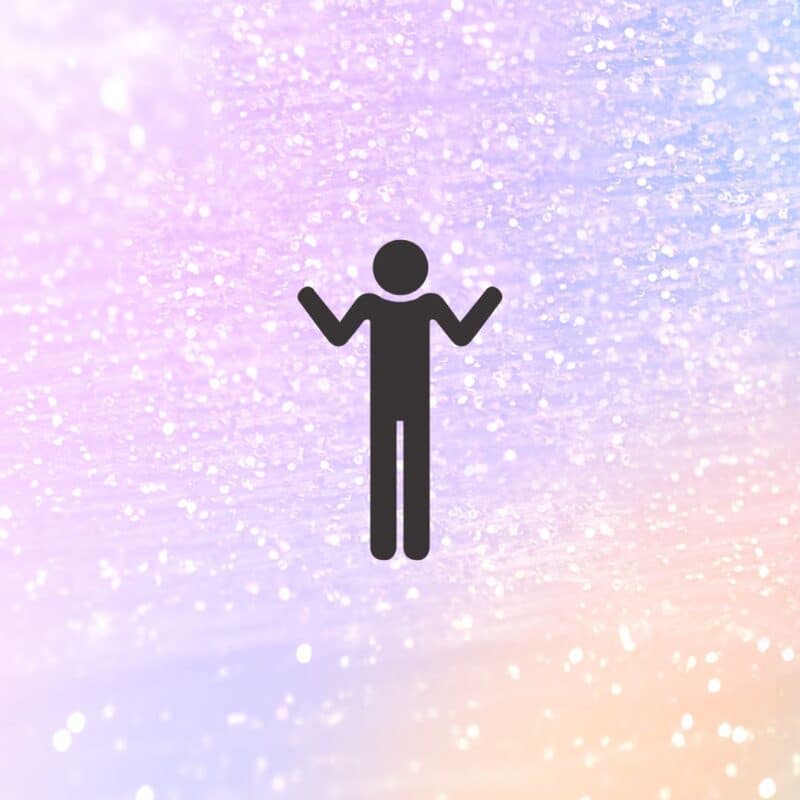 Silhouette of a person with raised arms against a glittery background