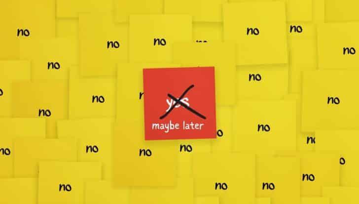A cluster of yellow sticky notes with the word 'no' surrounding a red note that says 'maybe later' with 'yes' crossed out 