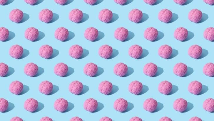 Pattern of pink brain-shaped objects on a light blue background