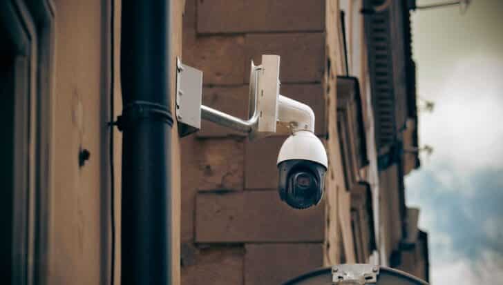 A surveillance camera mounted on the corner of a building