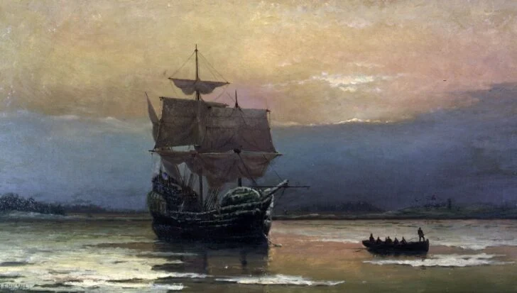 A ship with tall sails on calm waters during sunset, with a small boat carrying people nearby, related to the Pilgrims